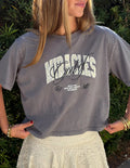 Woman wearing a relaxed-fit charcoal grey cropped graphic tee featuring the text God of Miracles