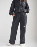 Washed charcoal black wide leg sweatpants with distressed vintage aesthetic
