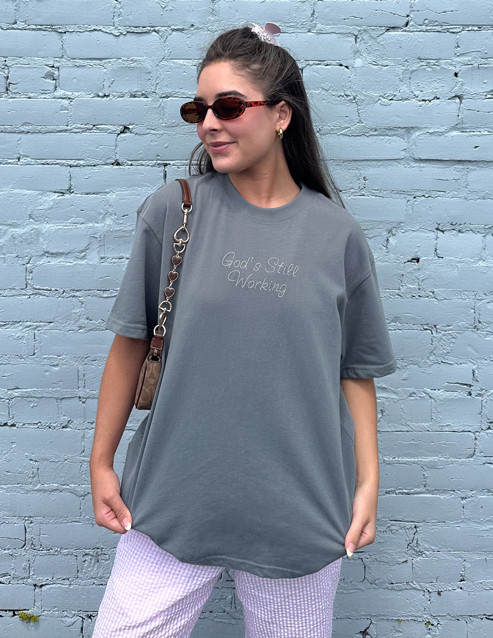 God's Still Working Unisex Graphic Tee in Charcoal Grey