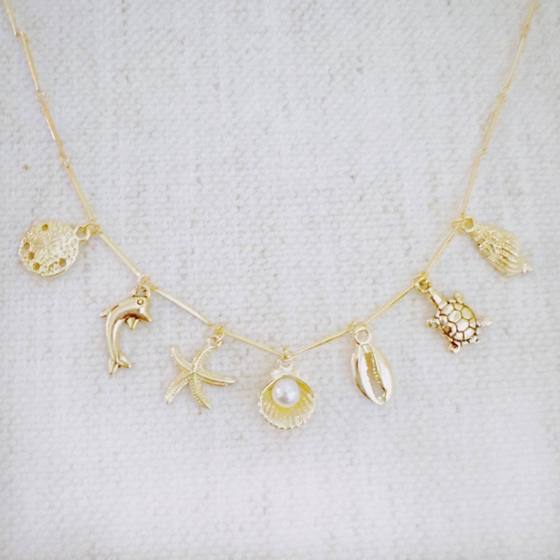Golden Sea Charm Necklace – Shell, Dolphin & Starfish