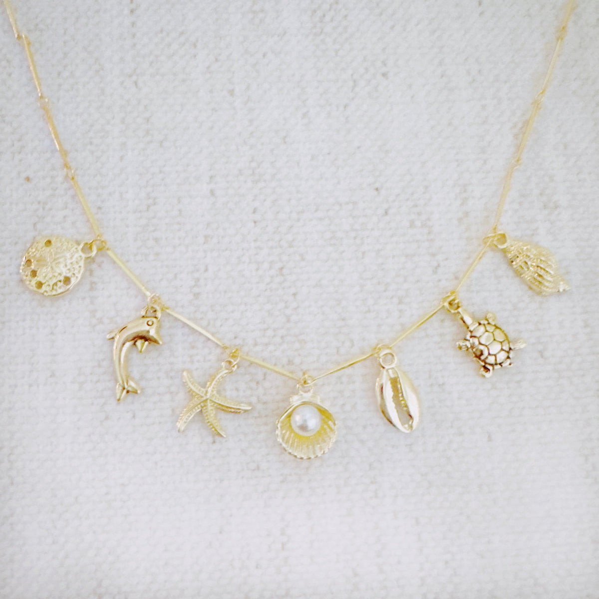 Golden Sea Charm Necklace – Shell, Dolphin & Starfish