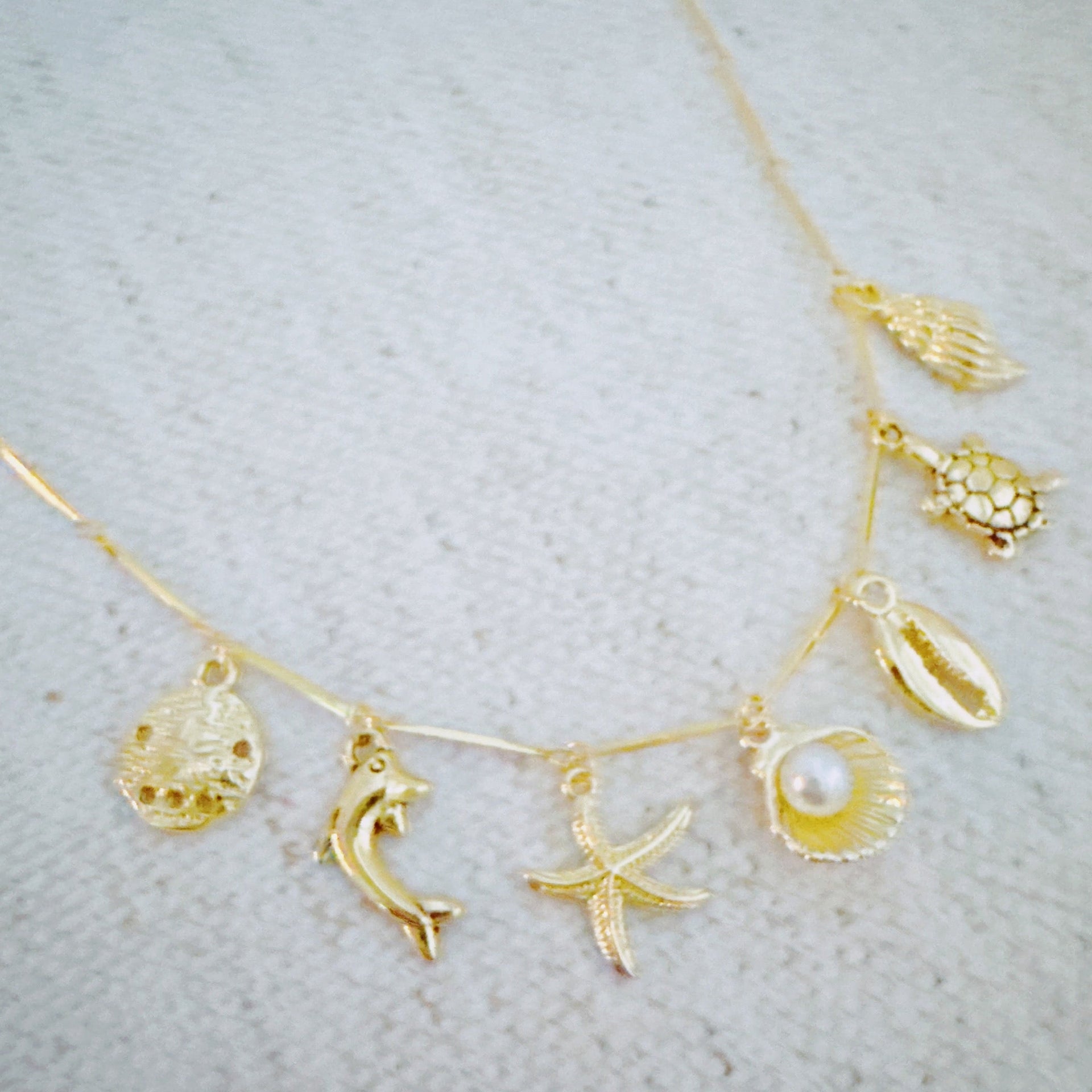 Golden Sea Charm Necklace – Shell, Dolphin & Starfish