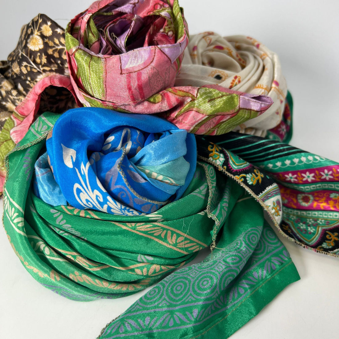 A unique, boho-style sash made from colorful reclaimed vintage sari fabric styled as a headband.