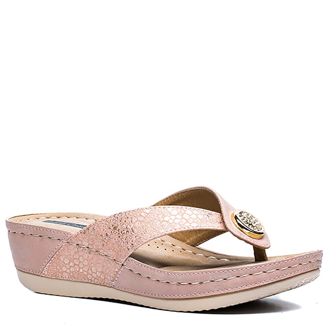 Pair of Dafni Blush Wedge Sandals for women, featuring a textured blush pink strap with a gold and rhinestone embellishment, a comfortable wedge heel, and a thong toe post.