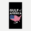 A rectangular beach towel featuring a black background with the text Gulf of America and a US map with an American flag pattern and an arrow pointing to the Gulf region.