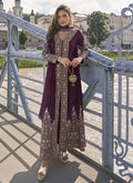 A wine-colored Pakistani designer salwar suit with intricate embroidery and full sleeves, styled with matching pants.