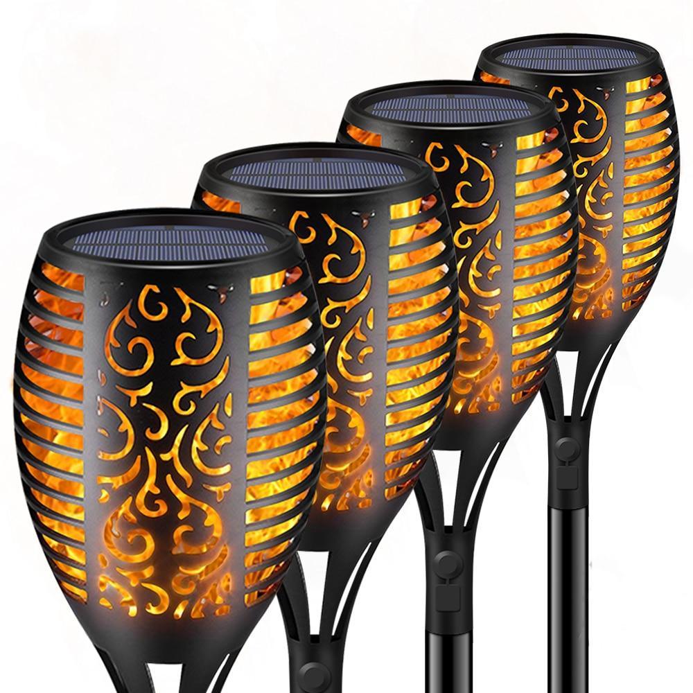Stainless steel solar LED torch lights featuring a realistic flickering flame effect in a garden pathway.