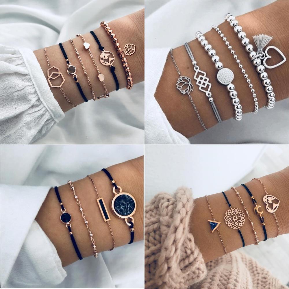 Boho chic multi-layer charm bracelet set with rose and map designs in gold-tone metal.