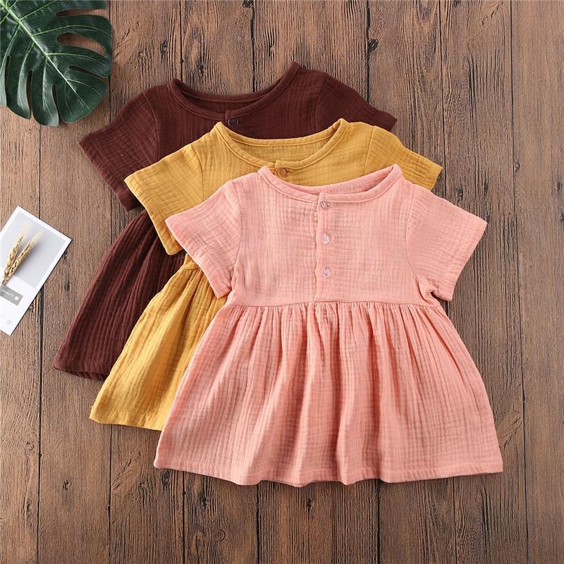 Toddler girl wearing a minimalist solid color A-line cotton dress
