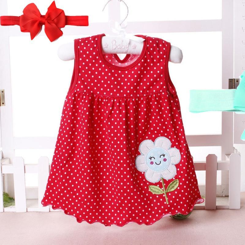 Baby girl wearing a polka dot tutu princess dress with floral details and headband