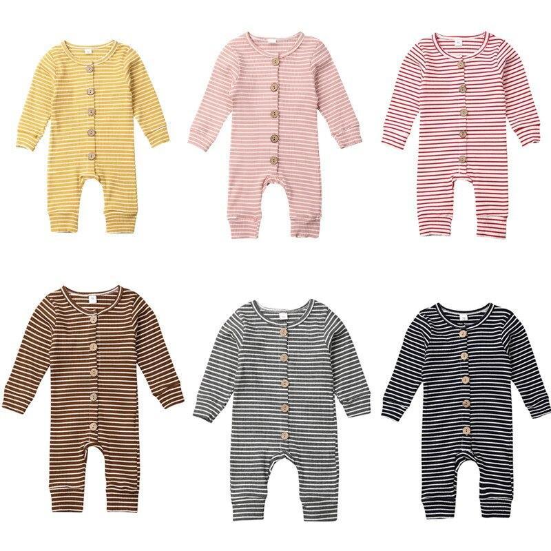 Baby wearing a trendy long-sleeve ripped jumpsuit in soft cotton blend fabric