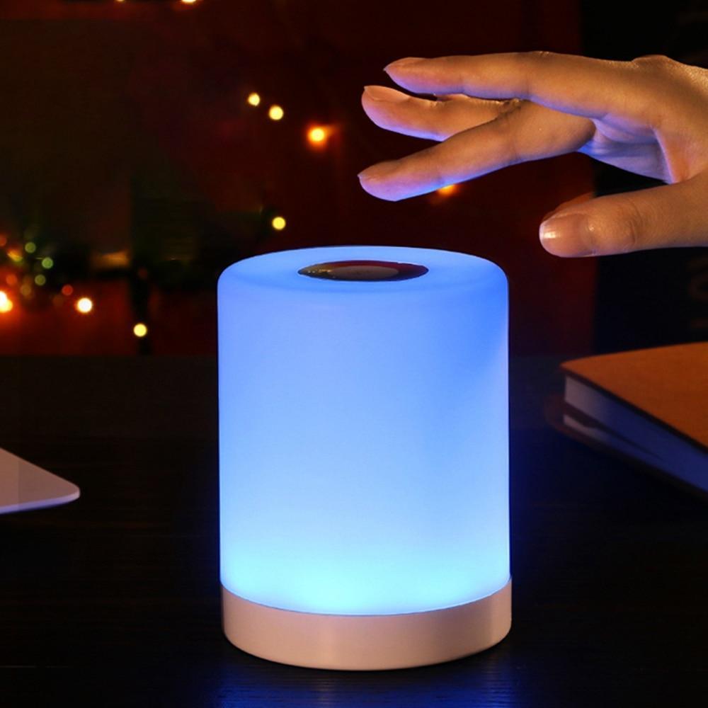 Modern smart touch-sensor LED lamp on a bedside table.