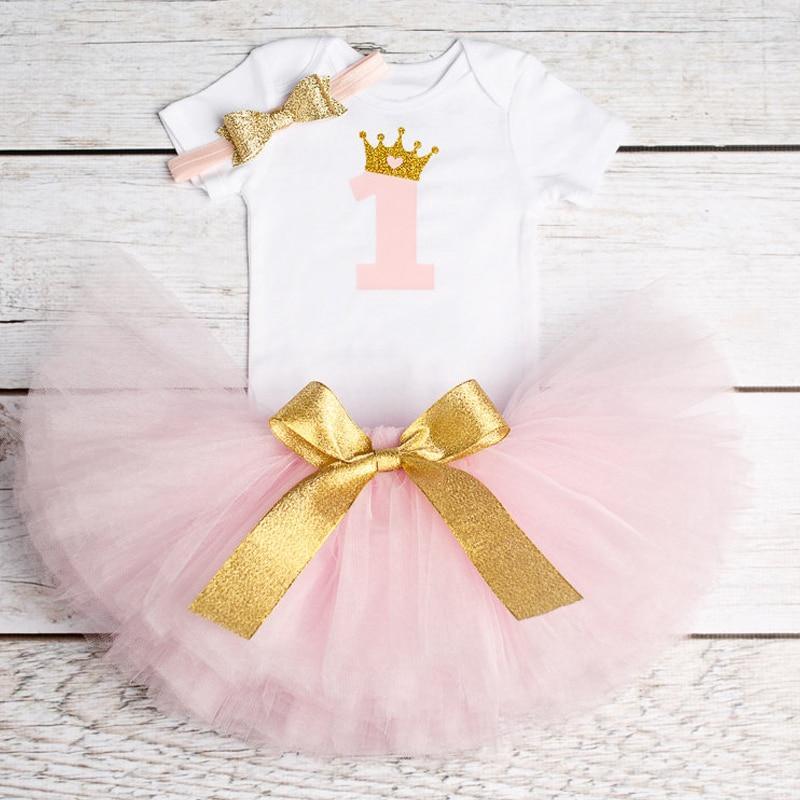 Baby girl wearing an 'It's my first birthday' tutu dress with a layered tulle skirt.