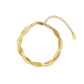 A close-up of the Ygraine Larue Gold Herringbone Twisted Chain Bracelet on a white background, showcasing its unique twisted design and lobster clasp. A second image shows the bracelet elegantly worn on a wrist.