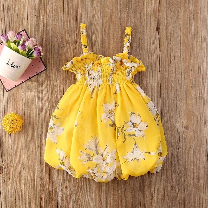 Bohemian toddler girl sleeveless dress in floral print with lace overlay.