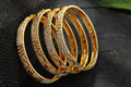 Golden AD stone embellished bangle set for women with polished finish