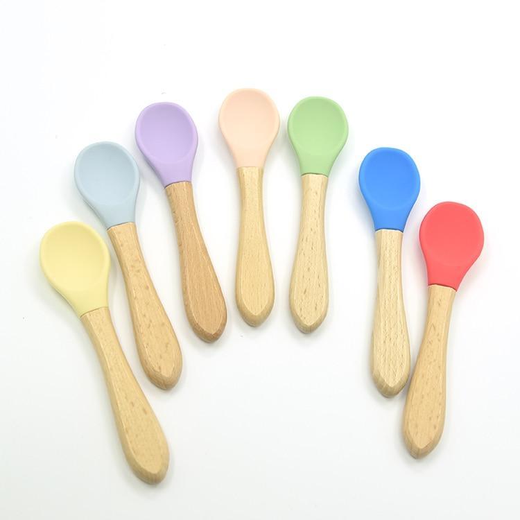 Set of two bamboo training spoons with colorful soft silicone tips in a minimalist aesthetic