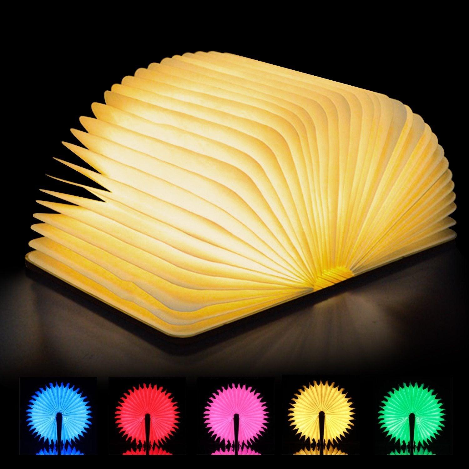 Foldable wooden book lamp open with a warm LED glow