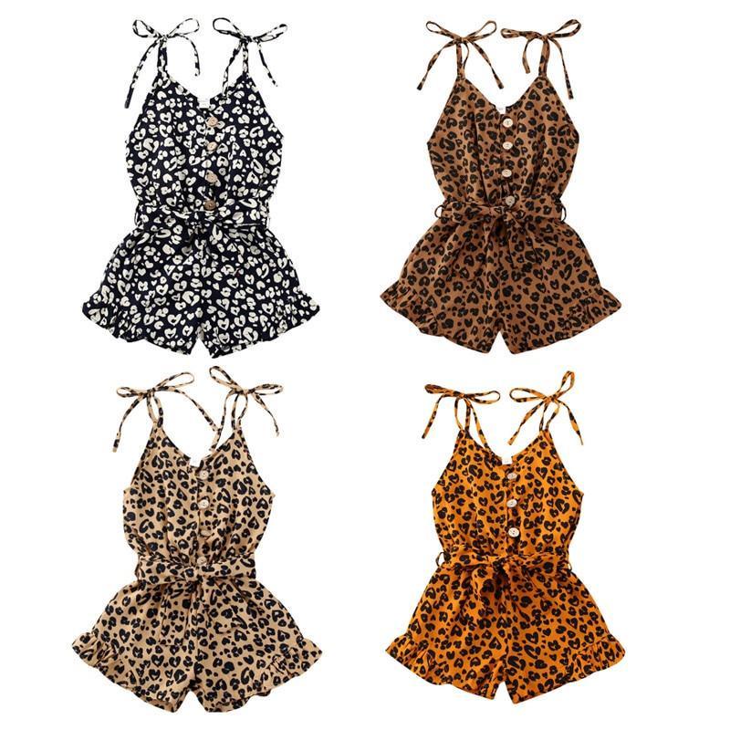 Baby girl wearing a sleeveless leopard print romper with a front bowknot button detail in a bohemian style.