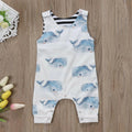 Baby wearing a sleeveless white and blue whale print cotton romper with snap closures
