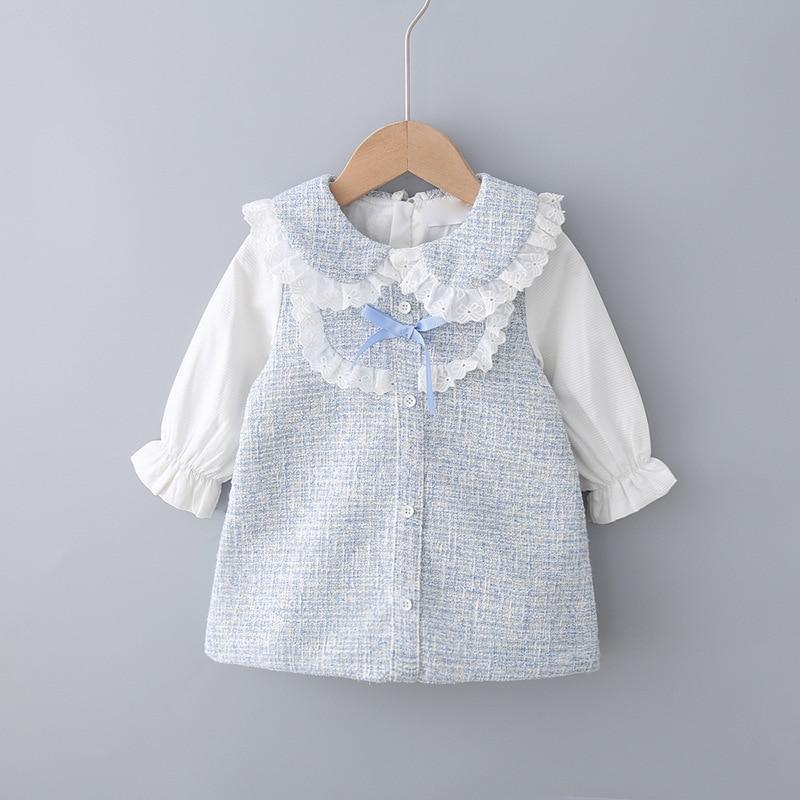 A classic romantic blue and white toddler princess dress with bow detail and removable pearl brooch.