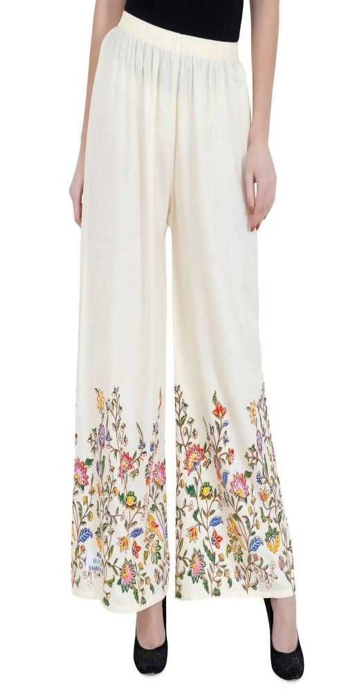 Off white palazzo pants featuring a subtle floral pattern