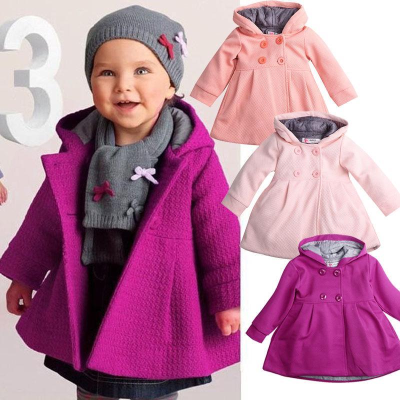 Baby girl wearing an elegant magenta hooded winter coat with classic princess styling