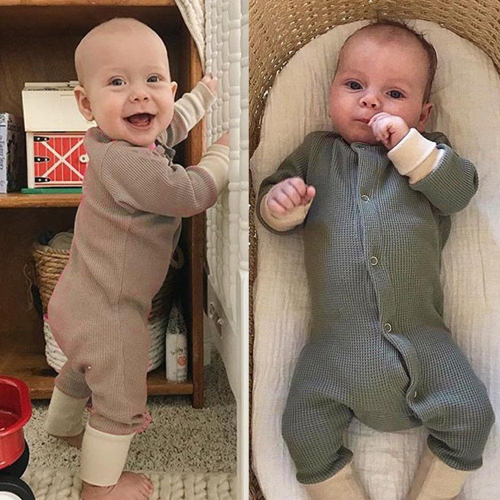 Baby in a solid color retro-style long sleeve romper with convenient button closures