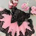 Girl wearing a glamorous A-line formal dress in high-contrast black and pink with cap sleeves.