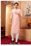 A toddler wearing a soft pink art silk kurta with off-white pyjama bottoms