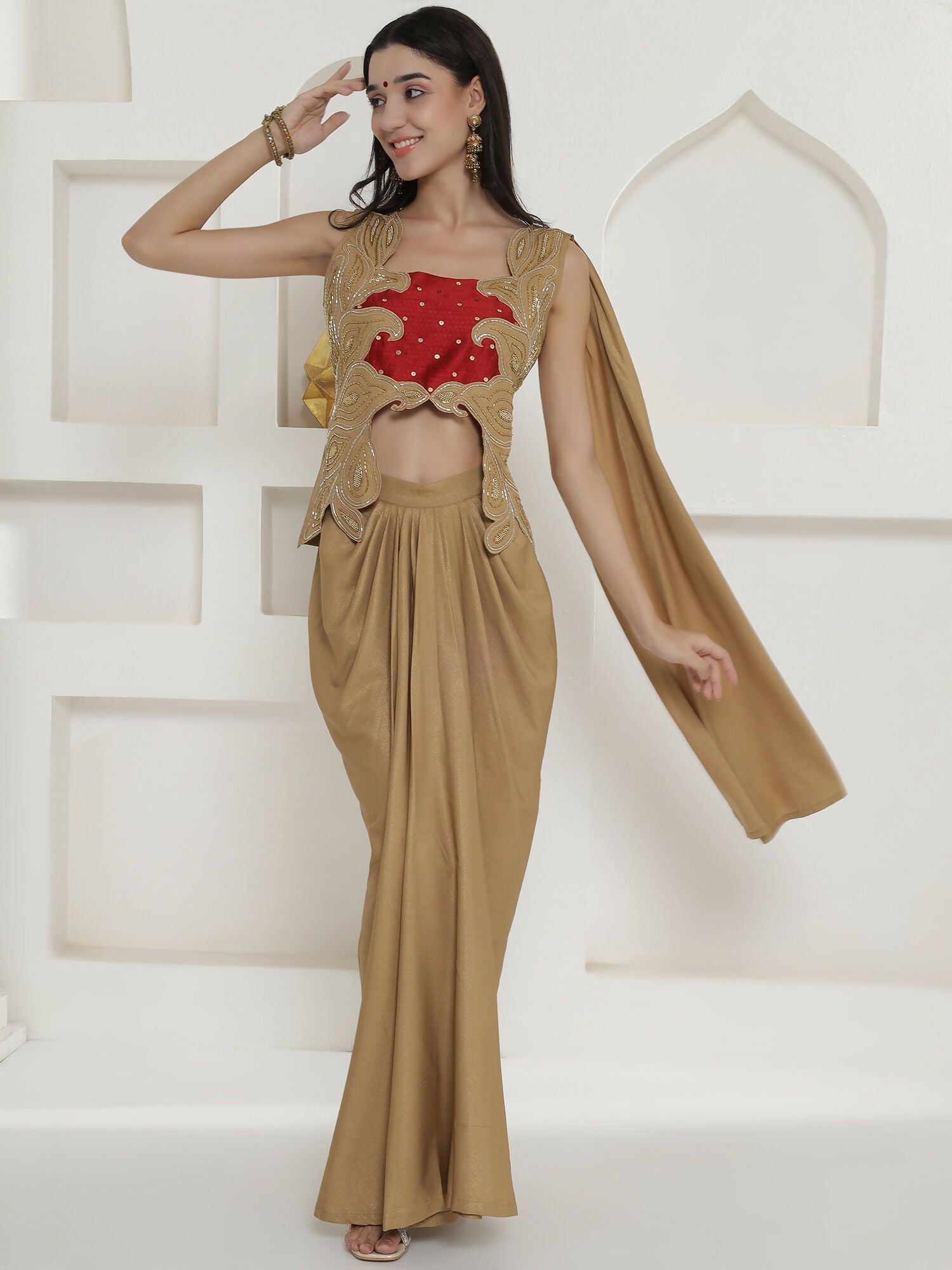 Woman wearing a golden shimmer chinnon skirt set with hand embellishments