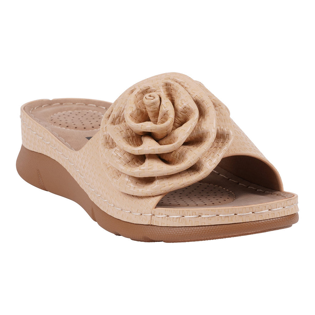 A pair of women's natural colored flat sandals featuring a large flower rosette detail on the strap, shown from a side angle.