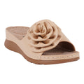 A pair of women's natural colored flat sandals featuring a large flower rosette detail on the strap, shown from a side angle.