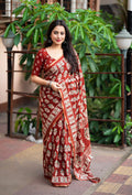 Red cotton blend Ajrak print saree with zari border and unstitched blouse piece