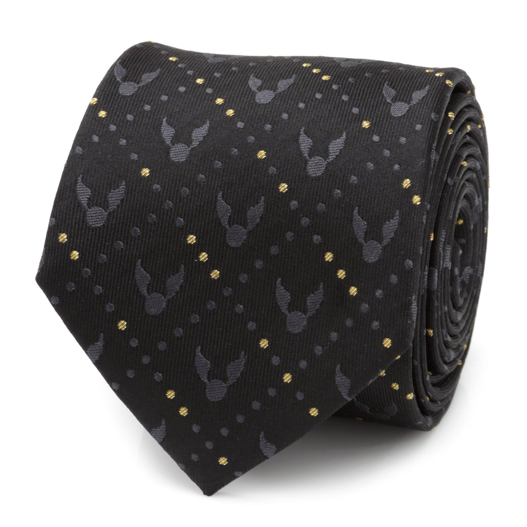 A rolled black silk necktie featuring a repeating Golden Snitch pattern and gold dot accents from Harry Potter.