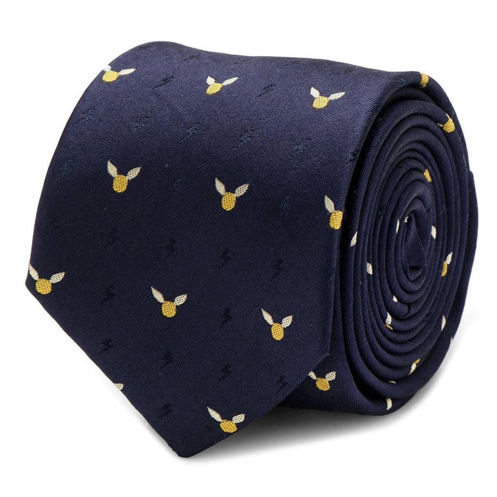 Close up and worn view of a navy blue silk necktie with a repeating Harry Potter golden snitch and lightning bolt pattern.