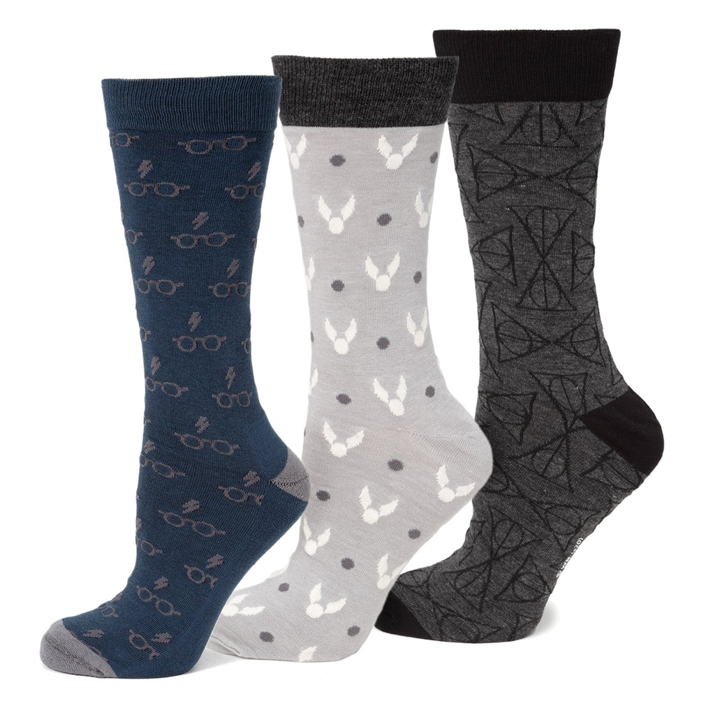 A 3-pack Harry Potter crew sock gift set featuring one pair of navy socks with glasses and scar, light grey with snitches, and dark grey with Deathly Hallows symbols.