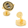 A pair of gold-tone Harry Potter Time Turner cufflinks featuring black enamel detail and an embossed logo on the backing