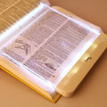Flat LED panel book light in white and translucent plastic for travel and night reading.