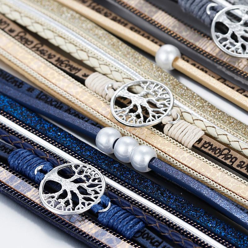 Multilayer bohemian leather cuff bracelet with a gold Tree of Life charm and magnetic clasp.