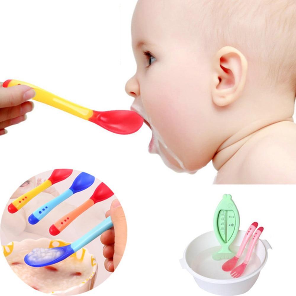 Temperature sensing soft silicone baby feeding spoon in pink, blue, yellow, and teal.