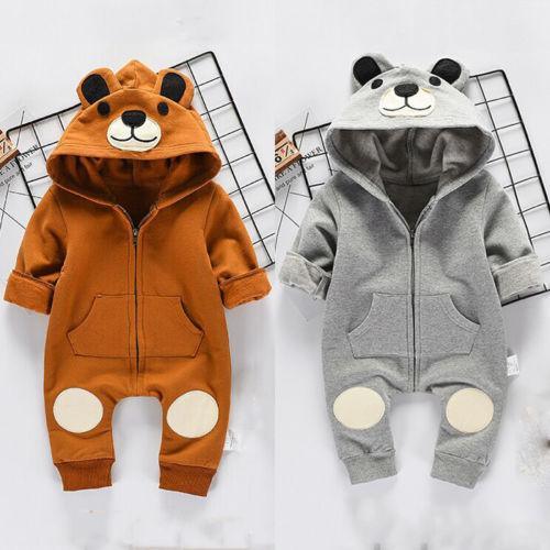 Baby wearing a brown plush hooded romper with bear ears and a front zipper