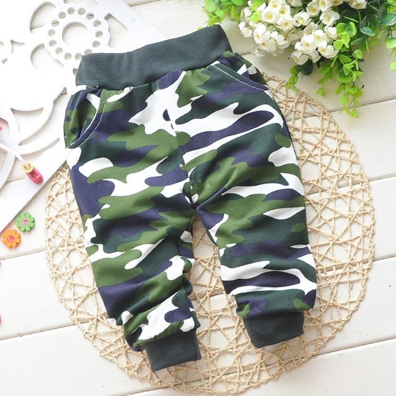 Unisex baby wearing relaxed-fit cotton camouflage pants in olive green and dark-grey