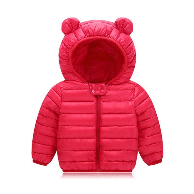 Baby wearing a colorful padded winter jacket with cute bear ears on the hood