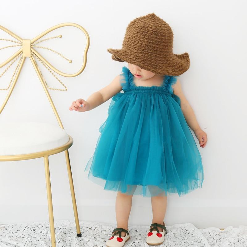 Baby girl wearing a sleeveless lace princess dress with round neck for birthday parties