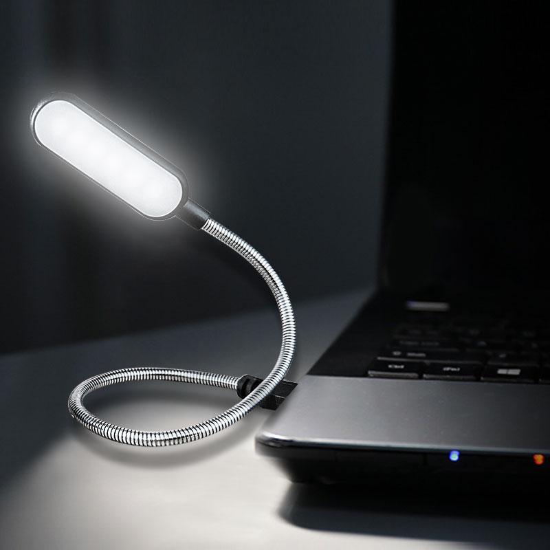 Flexible black USB LED reading light plugged into a laptop