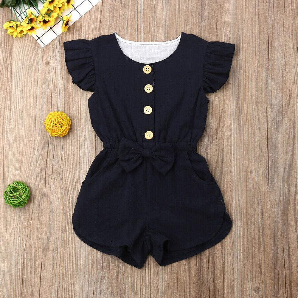 Baby girl wearing a sleeveless ruffle playsuit with button detail