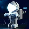 A modern white LED astronaut-themed desk lamp with a flexible gooseneck on a wooden surface.
