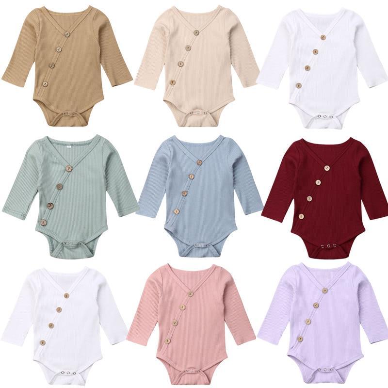 Minimalist knitted cotton baby romper in soft pastel tones