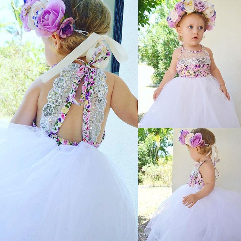 Baby girl wearing a handmade floral sequin tulle tutu dress for a wedding